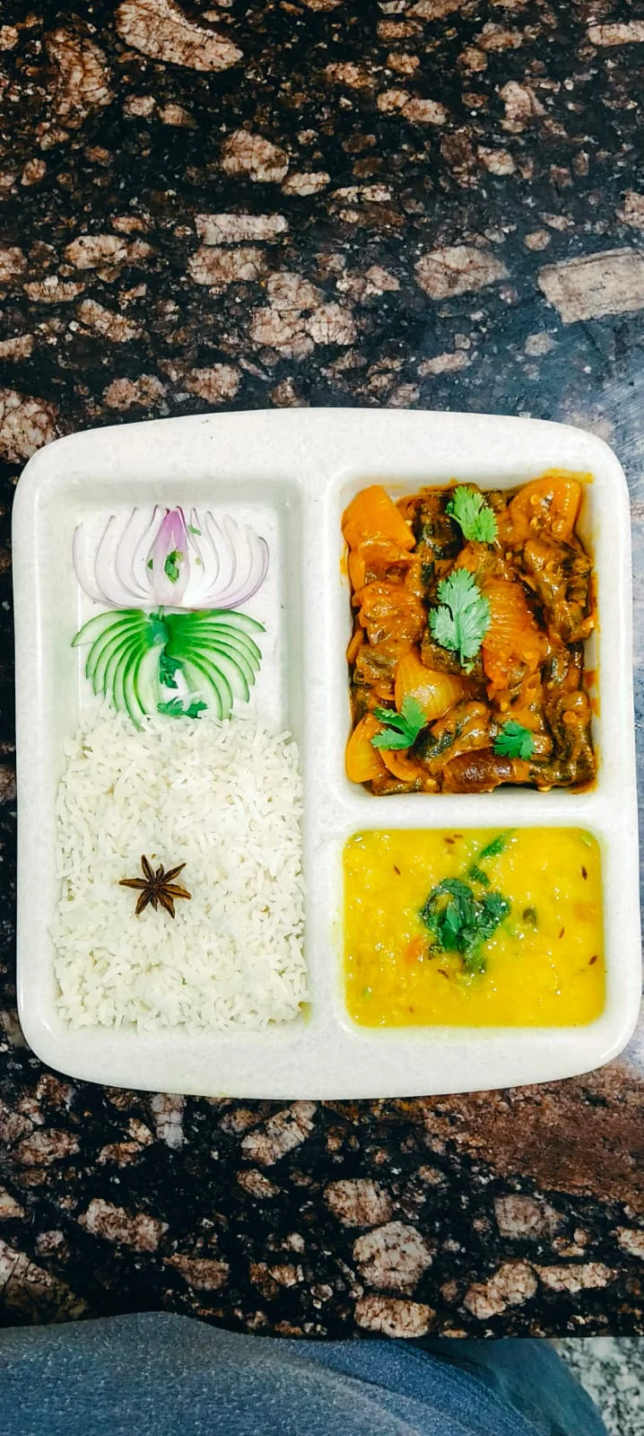 Rice and curry served in a meal tray.