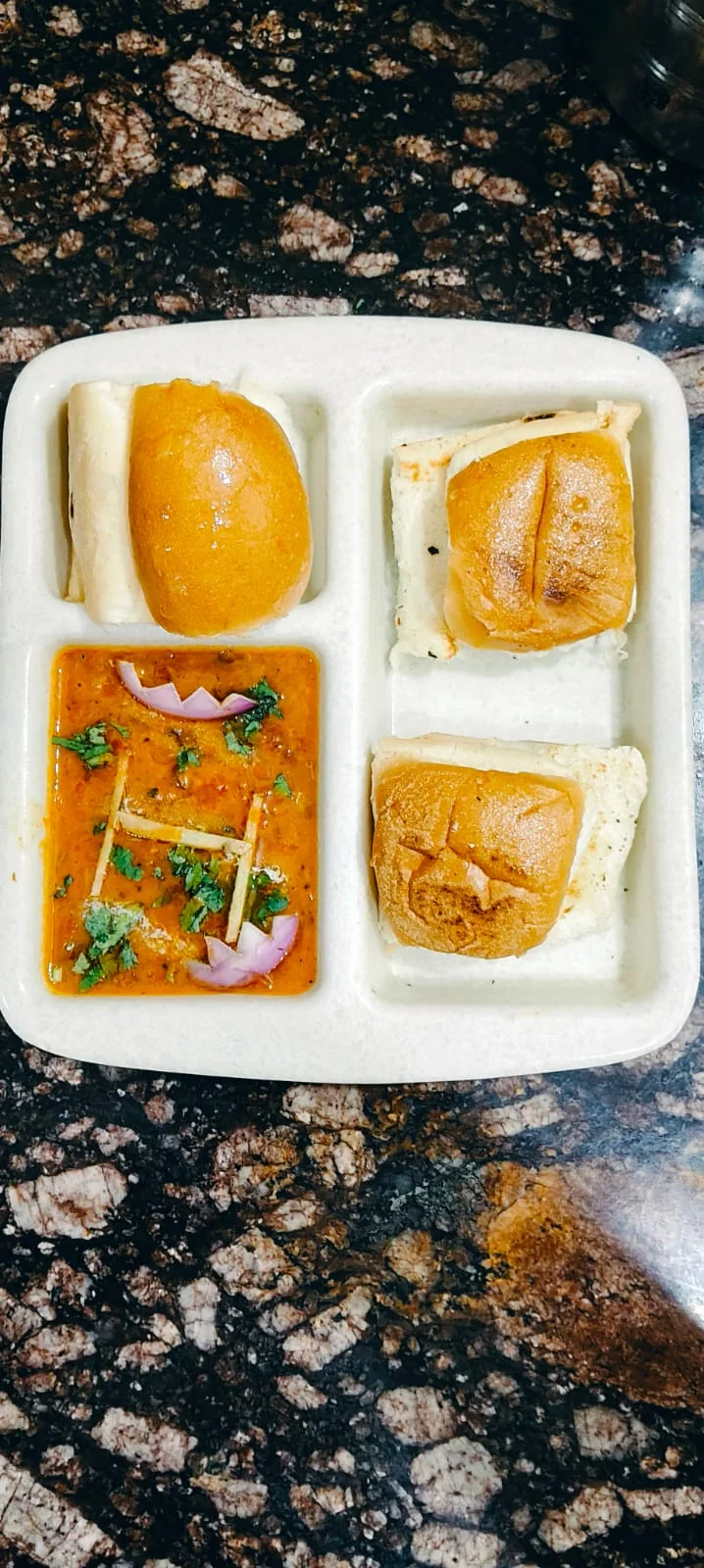 Rice, curry and vegetables in a compartment meal tray.