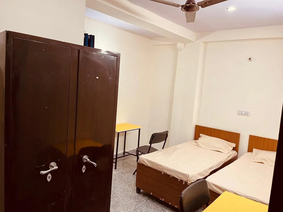 A room with a bed and a bathroom doorway visible.